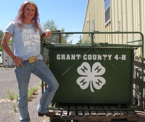Woman standing next to green 4-H scale